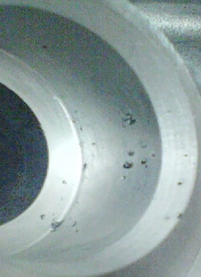 Casting porosity is primarily caused by the material's natural contraction as it cools.