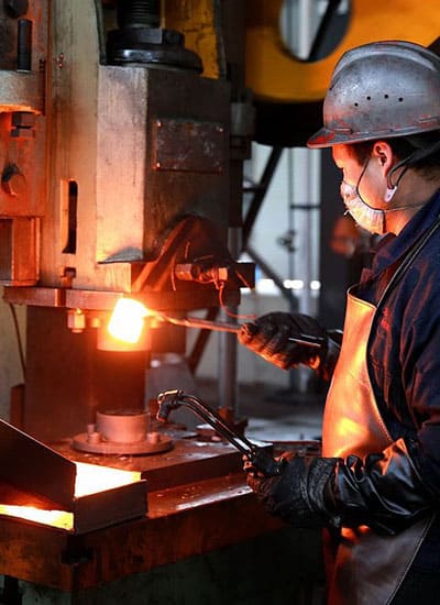 Aluminium forging process using a high-pressure hydraulic press machine in an industrial setting